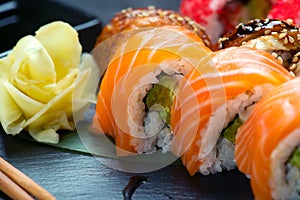 Sushi roll Japanese food in restaurant. California Sushi roll set with salmon, vegetables, flying fish roe and caviar