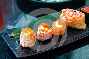 Sushi roll japanese food in restaurant. with salmon, vegetables, flying fish roe and caviar closeup.