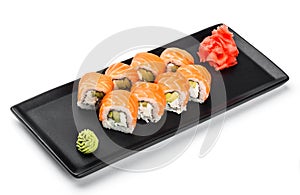 Sushi Roll - Maki Sushi made of salmon, avocado and cream cheese on black plate isolated over white background.