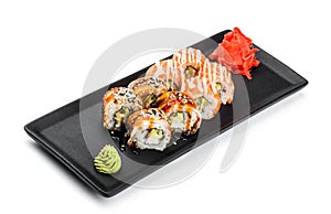 Sushi Roll - Maki Sushi made of salmon, smoked eel, cucumber, avocado and cream cheese on black plate