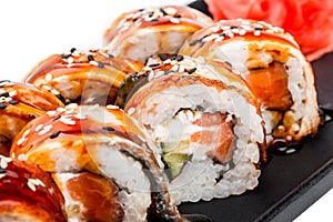 Sushi Roll - Maki Sushi made of salmon, smoked eel, cucumber, avocado and cream cheese on black plate