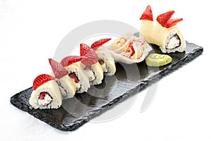 Sushi roll with Philadelphia cheese and strawberries, on white background