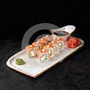 Sushi roll-Philadelphia with salmon, smoked eel, avocado, cream cheese on black background. Sushi menu. Japanese food