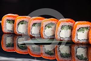 Sushi roll (Philadelphia) with salmon smoked eel avocado cream cheese on black background. Sushi menu. Japanese food