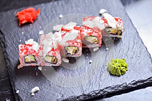 Sushi roll Philadelphia with salmon, tuna, avocado, cream cheese, passion fruit sauce. Sushi menu. Japanese food.