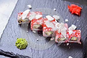 Sushi roll Philadelphia with salmon, tuna, avocado, cream cheese, passion fruit sauce. Sushi menu. Japanese food.