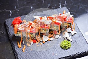 Sushi roll Philadelphia with salmon, tuna, avocado, cream cheese, passion fruit sauce. Sushi menu. Japanese food.