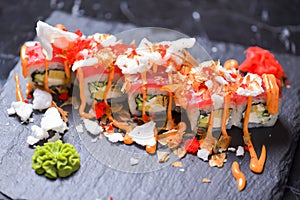 Sushi roll Philadelphia with salmon, tuna, avocado, cream cheese, passion fruit sauce. Sushi menu. Japanese food.