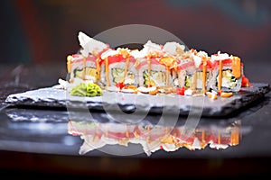 Sushi roll Philadelphia with salmon, tuna, avocado, cream cheese, passion fruit sauce. Sushi menu. Japanese food.