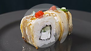 Sushi roll rotated on black background. Sushi japanese food in restaurant. Sushi roll set with salmon, vegetables