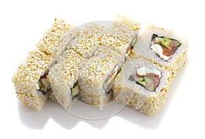 Sushi roll with salmon cheese and vegetables rolled in sesame isolated