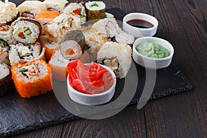 Sushi Roll with salmon, eel, tuna, avocado, cream cheese Philadelphia, caviar tobica, chuka. Sushi menu. Japanese food on table