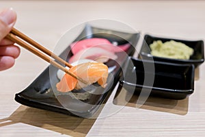 Sushi roll with salmon and and fresh mix sushi set in black plate - Japanese food set style at Japanese restaurant