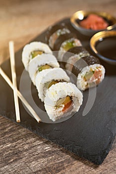 Sushi roll set on the black plate.