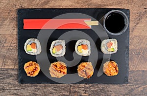 Sushi roll set on the black plate.