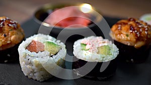 Sushi roll set on the black plate.