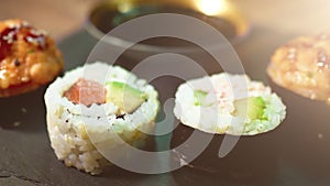 Sushi roll set on the black plate.