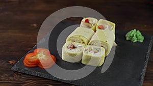 Sushi roll set on the table. Various Japanese dishes are served at the restaurant. Set with salmon, tuna, vegetables