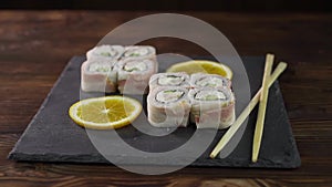 Sushi roll set on the table. Various Japanese dishes are served at the restaurant. Set with salmon, tuna, vegetables