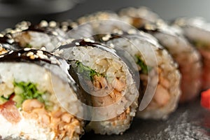 Sushi Roll with shrimp, cucumber, fried salmon and cheese philadelphia. Sushi menu. Japanese food. Futomaki