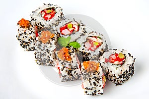 Sushi roll with shrimp, flying fish roe, salmon and black sesame