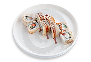 Sushi roll with smoked eel and vegetables. On a white ceramic plate. White background. Isolated