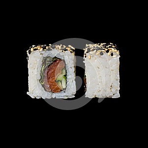 Sushi. Roll with smoked salmon, lola ross salad, cucumber and fried sesame, isolated in black background