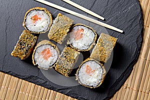 Sushi roll tempura with prawns on the mats background. Top view of sushi . Sushi food photo for menu