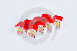 Sushi Roll with tuna and avocado inside roll isolated on light gray background. Sushi served with red flying fish roe Tobiko cavi