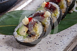 Sushi roll with tuna, avocado, red caviar and wasabi