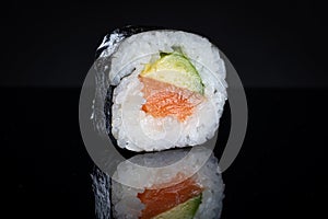 Sushi roll with tuna and avocado. Sushi with reflection. Traditional japanese food