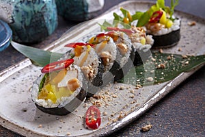 Sushi roll with tuna, cucumber, cheese and chickpeas