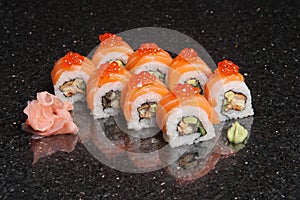 Sushi rolls on black marble background. Fresh Hosomak, Maki, Nigiri, Tempura, Uramaki, Philadelphia pieces with rice, nori, fish