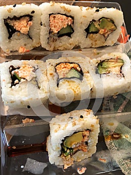 sushi rolls (california rolls) crab, avocado, rice, seaweed.