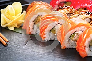 Sushi rolls closeup. Japanese food in restaurant. Roll with salmon, eel, vegetables and flying fish caviar