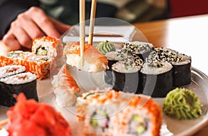 Sushi and rolls, Japanese cuisine, a girl eating sushi