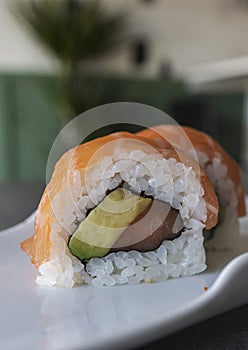 Sushi rolls Japanese food. California sushi roll with tuna, avocado and salmon close up. Japanese restaurant menu