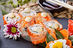 Sushi Rolls - Maki Sushi sashimi decorated with flowers. Japanese cuisine. Selective focus.