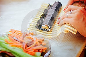 Sushi rolls making hands at home