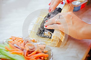 Sushi rolls making hands at home