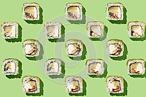 Sushi rolls pattern on mint background