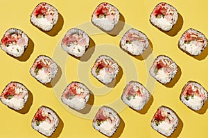 Sushi rolls pattern on yellow background