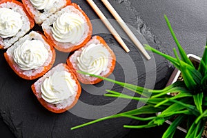 Sushi rolls Philadelphia with salmon and topped with cream cheese