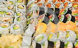 Sushi rolls with salmon, avocado, tuna and cucumber. Fresh maki with rice and nori. Delicious Japanese food with sushi roll in