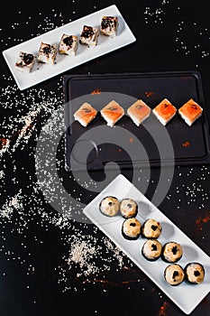 Sushi and rolls set on black background