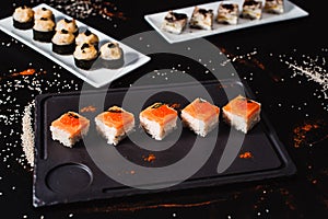 Sushi and rolls set on black background