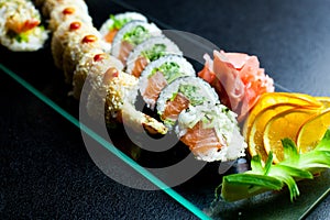 Sushi rolls set served on glass plate
