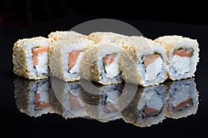 Sushi rolls shake chizu with sesame on a black background.