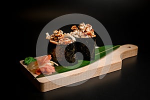 Sushi rolls sprinkled with fried pieces of fish