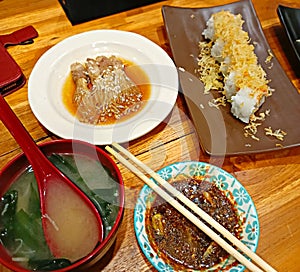 Sushi rolls on wooden table with wasabi and soy souce